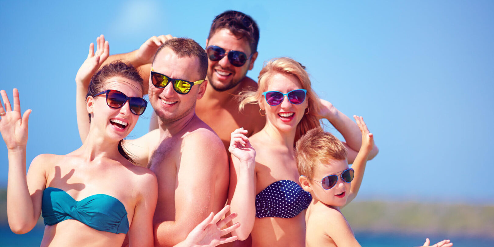 group of happy friends, family having fun on yacht, during summer vacation
